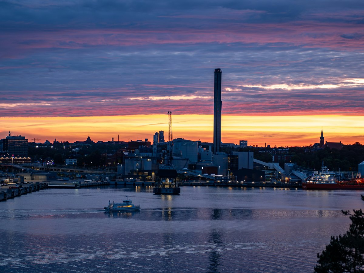 A view of a city and a body of water at sunset