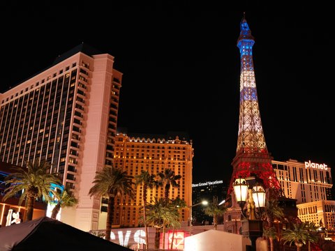 Las vegas strip hotels and eiffel tower replica at night.