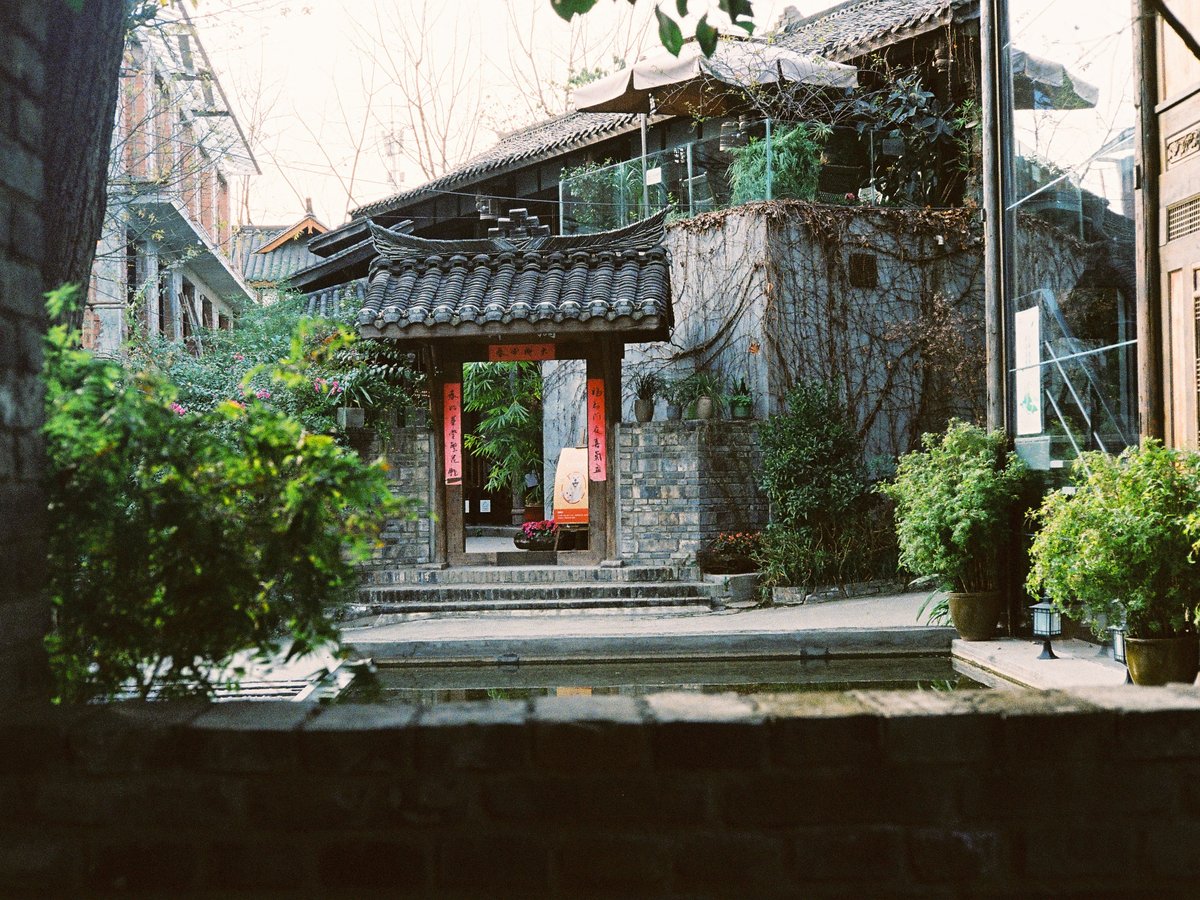 a stone building with a red door in front of it