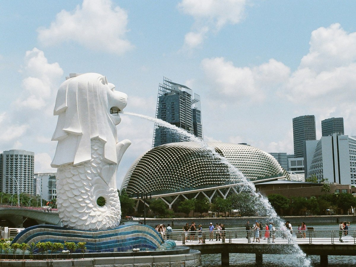 white concrete statue near city buildings during daytime