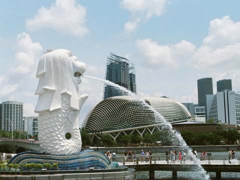 white concrete statue near city buildings during daytime
