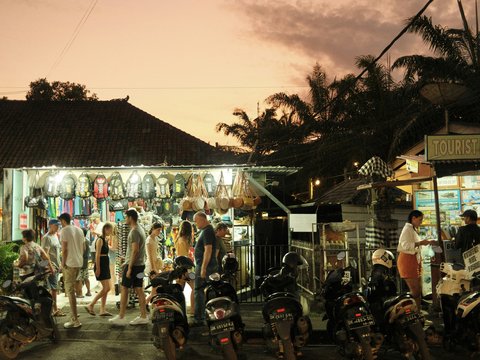 a group of people stand outside a shop
