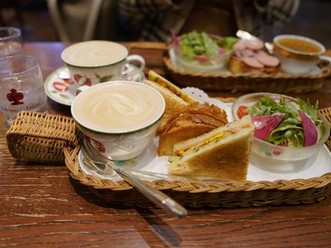 A wooden table topped with two baskets filled with food