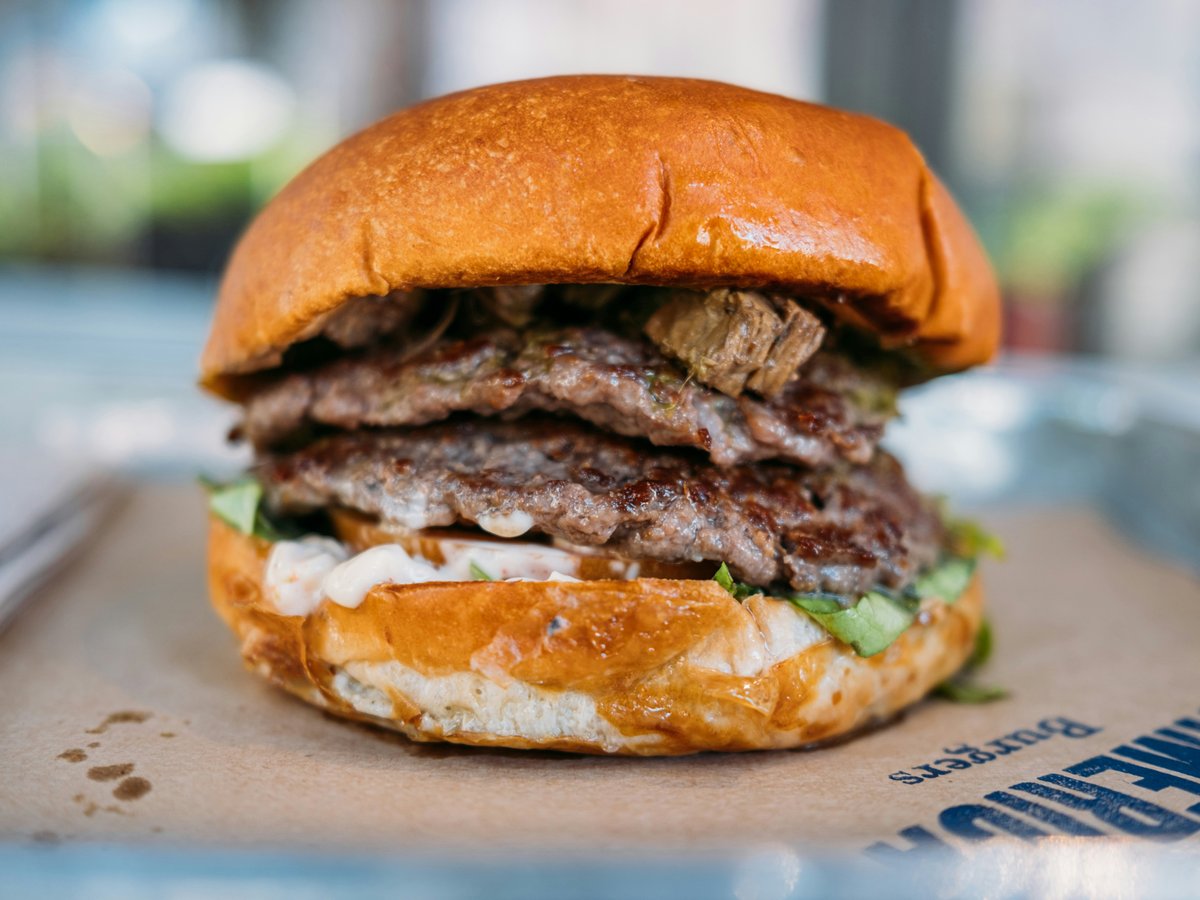 a close up of a hamburger on a tray