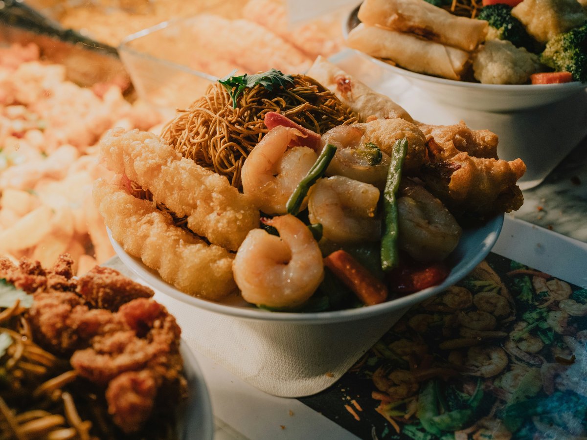 Diverse asian food is served in bowls.