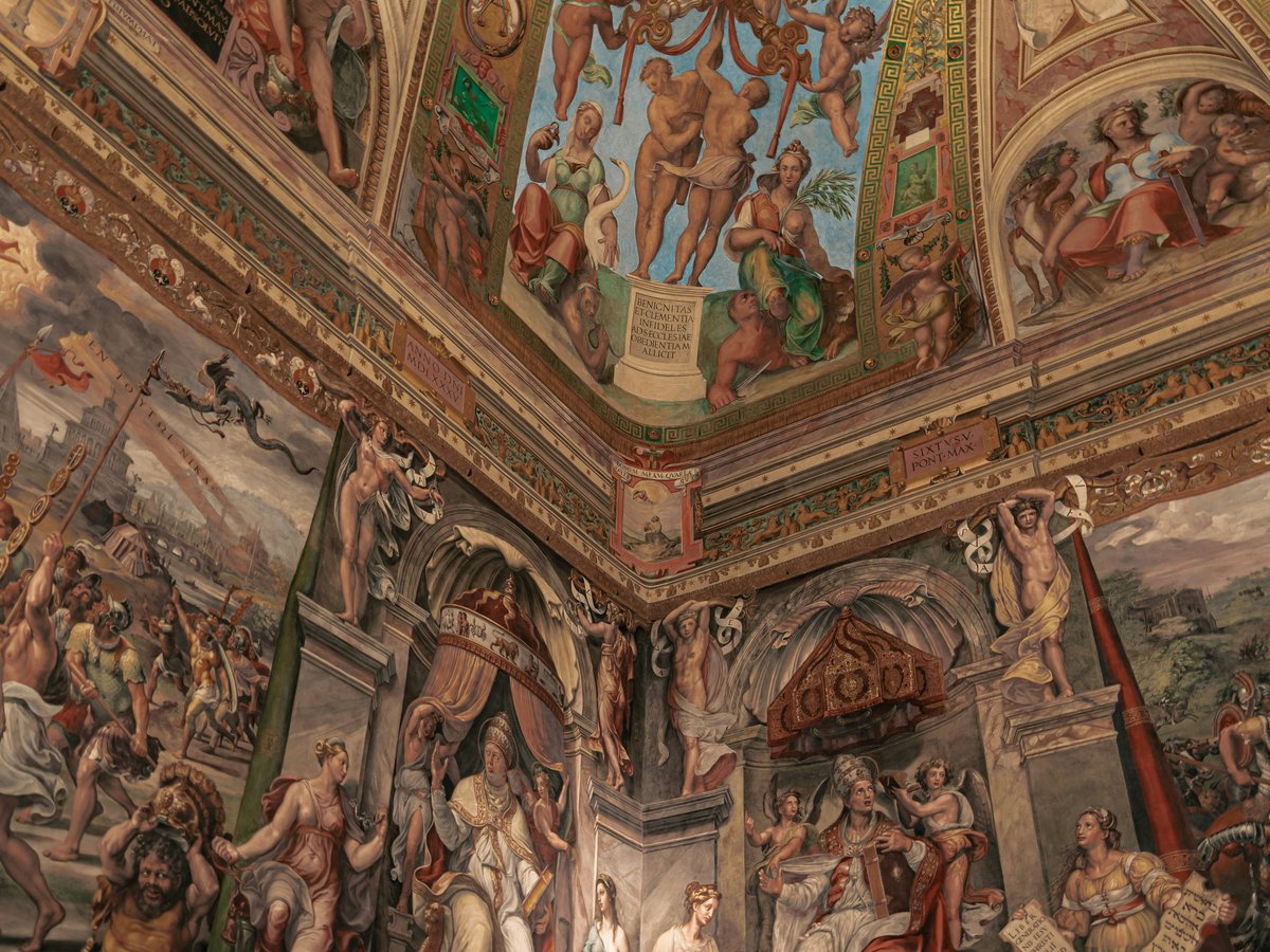 a large painting on the ceiling of a building