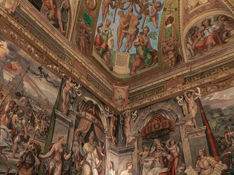 a large painting on the ceiling of a building