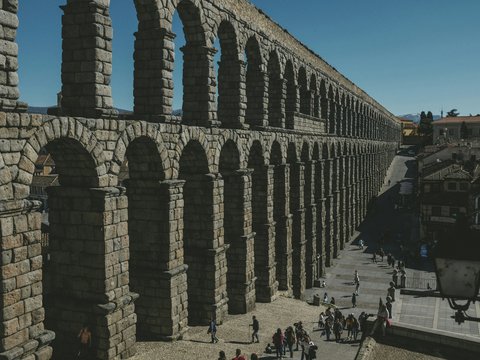 people walking on gray concrete bridge during daytime
