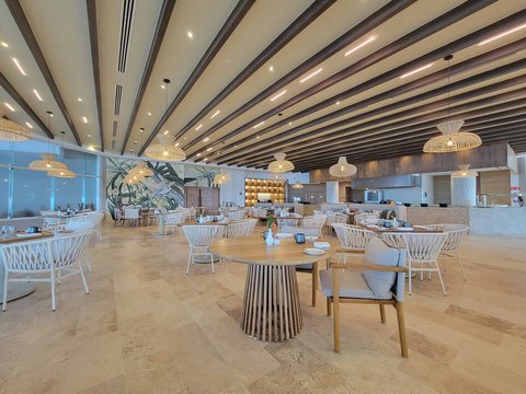 A large room with tables and chairs and lights