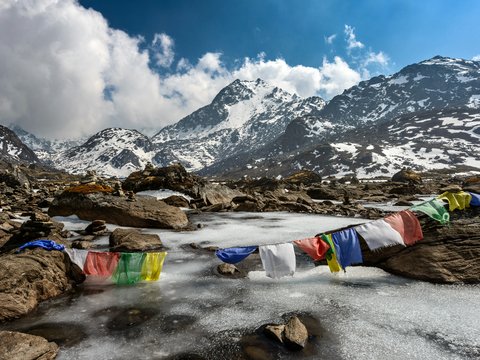 assorted-color of apparel hanged below creek across glacier mountain