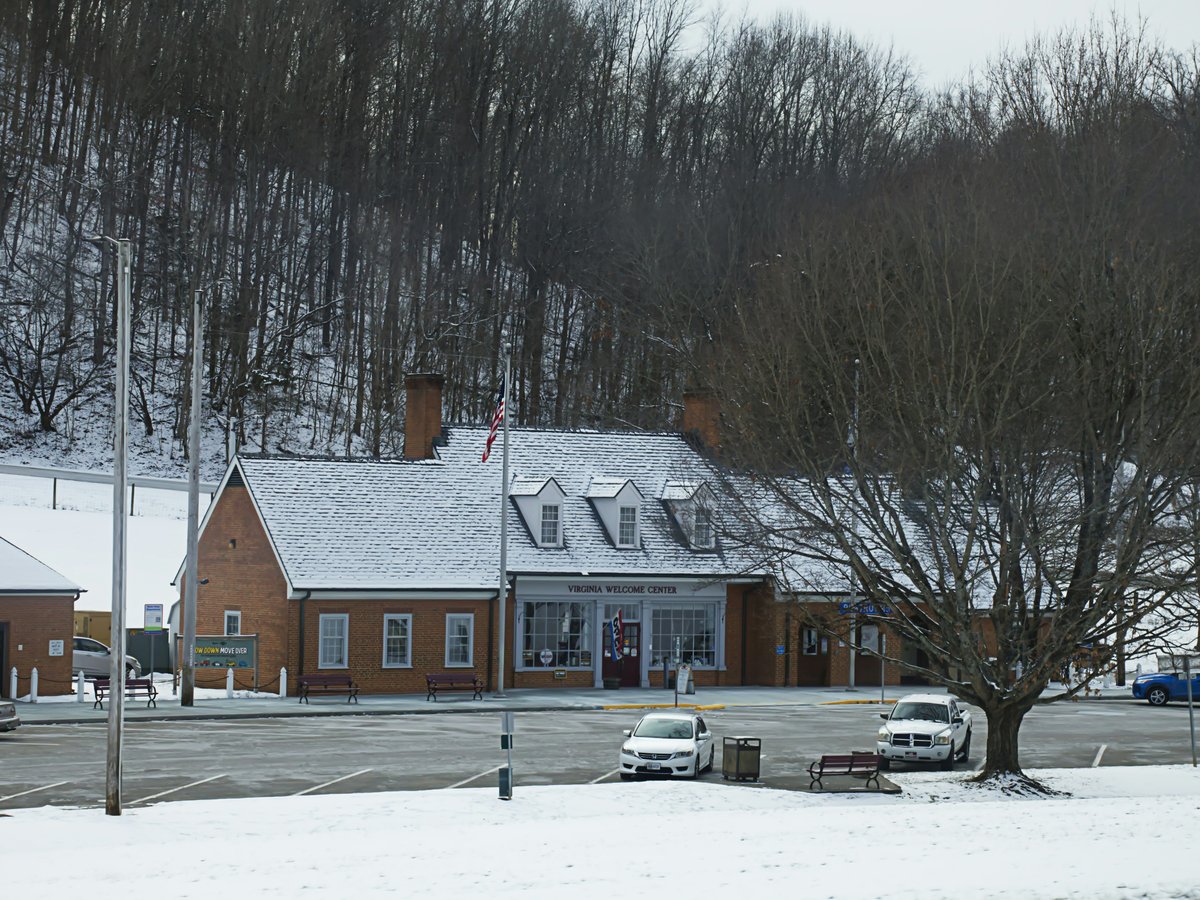 A snow covered parking lot next to a building
