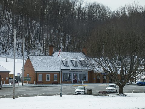 A snow covered parking lot next to a building