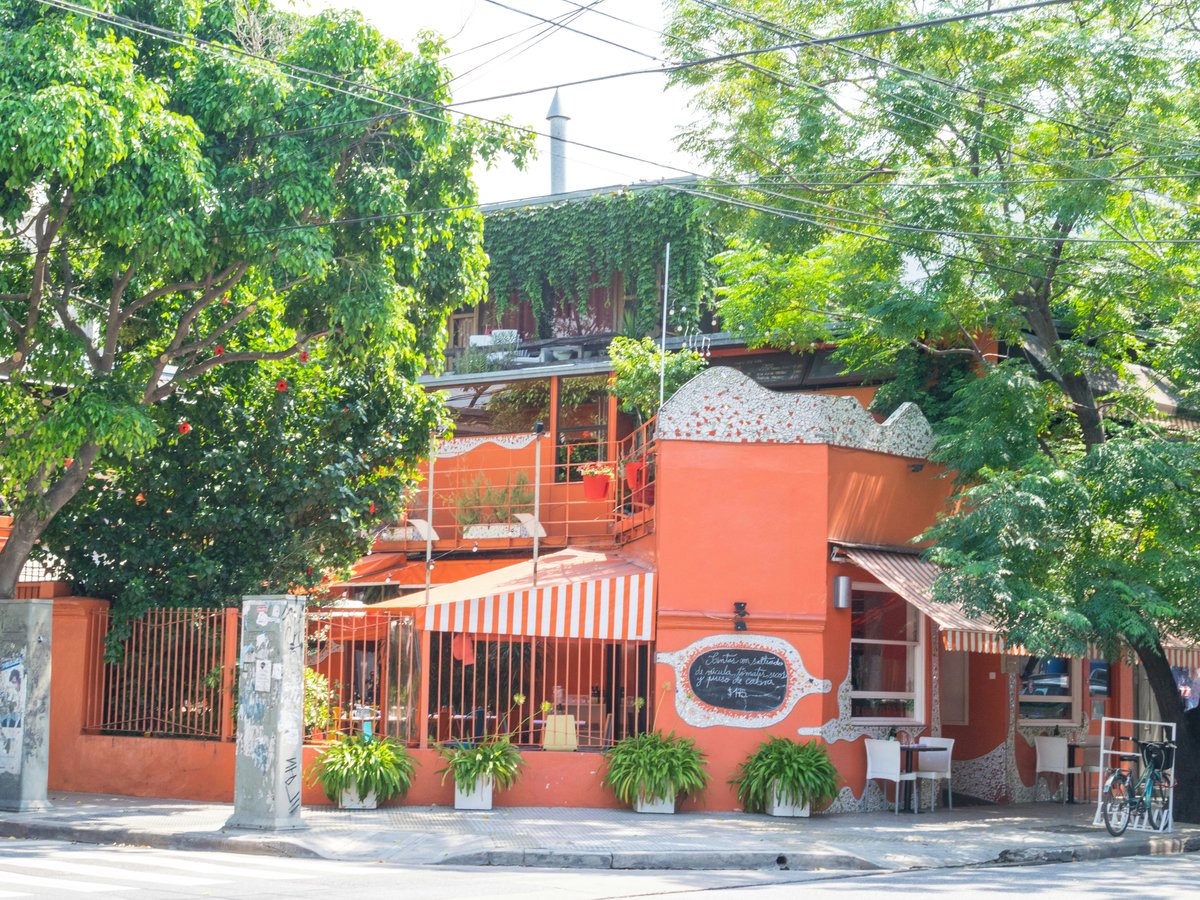 brown wooden house near green trees during daytime