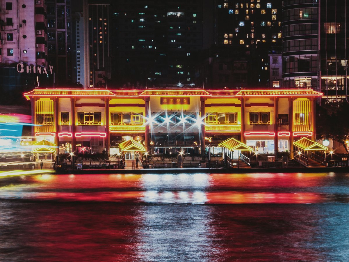 a brightly lit building in a city at night