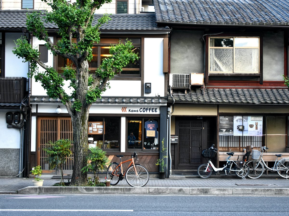 black bicycle parked beside brown and white concrete building during daytime
