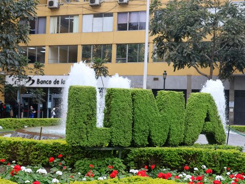 A large sign that is in the middle of a garden
