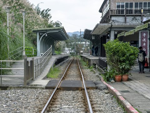 a person standing next to a train track