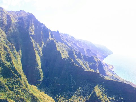 a scenic view of a mountain with a body of water in the background