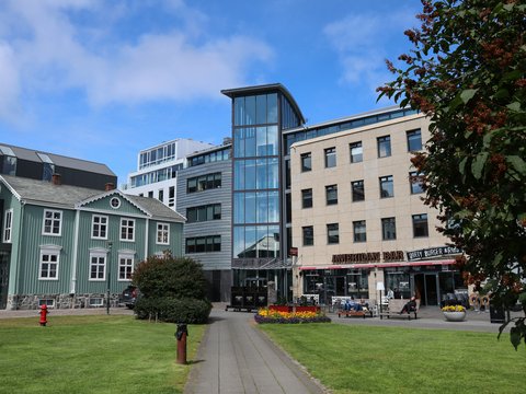 a building with a walkway and grass