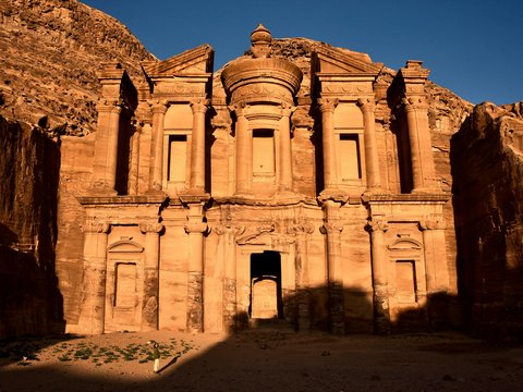 a large stone building in the middle of a desert