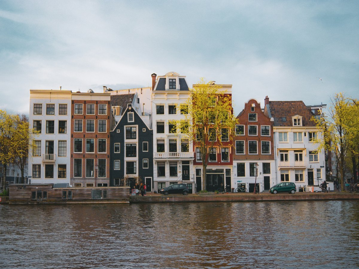 a row of houses on the side of a river