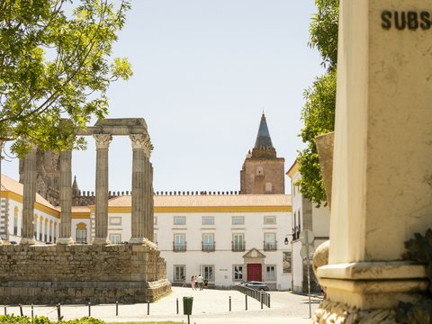 a view of a building with a clock tower in the background