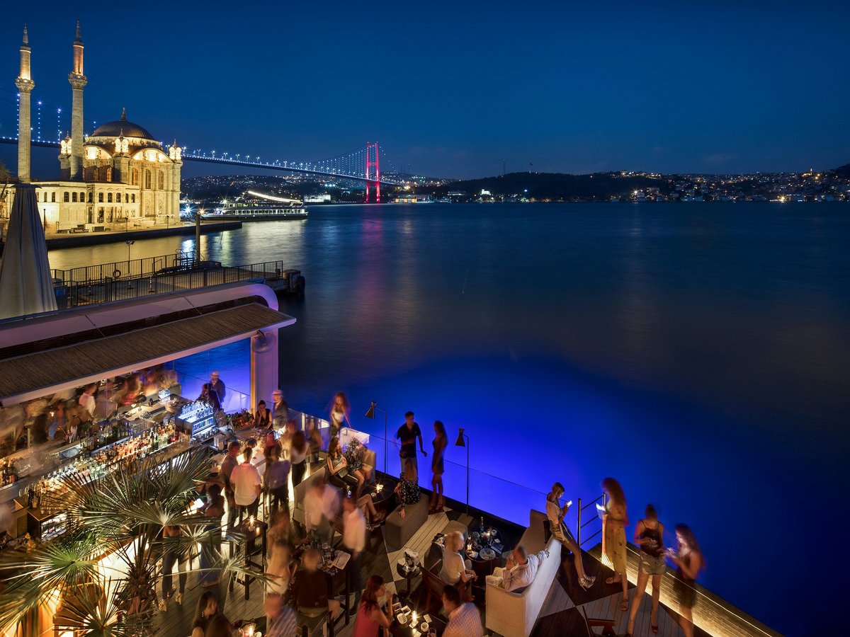 people at the pier near bridge during night