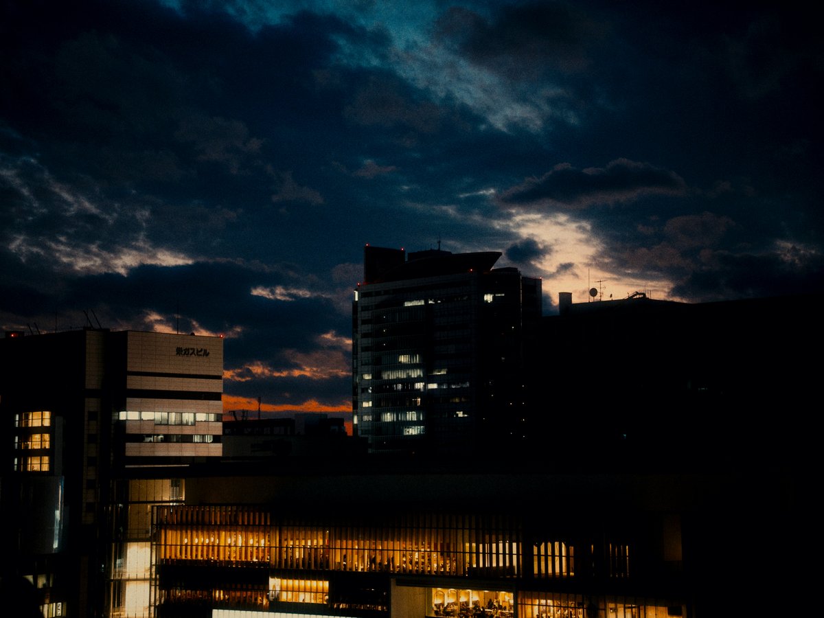 City skyline with illuminated buildings at dusk