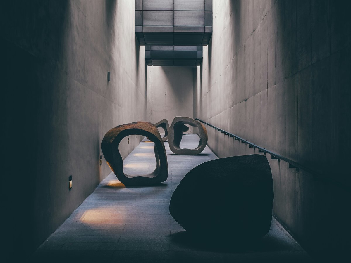 a couple of large sculptures sitting on top of a cement floor