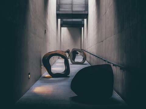 a couple of large sculptures sitting on top of a cement floor