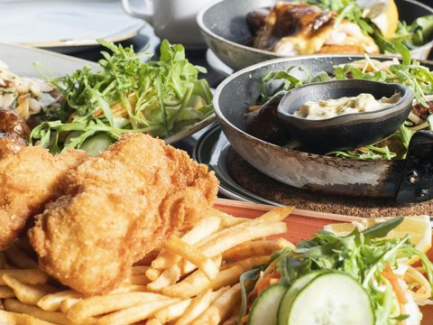 fried chicken and fries on black ceramic bowl