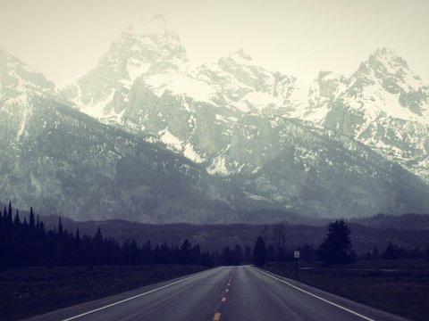a road with a mountain in the background