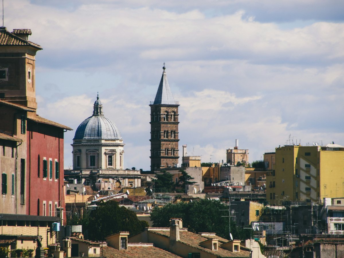 Rooftops and historic buildings under a cloudy sky.
