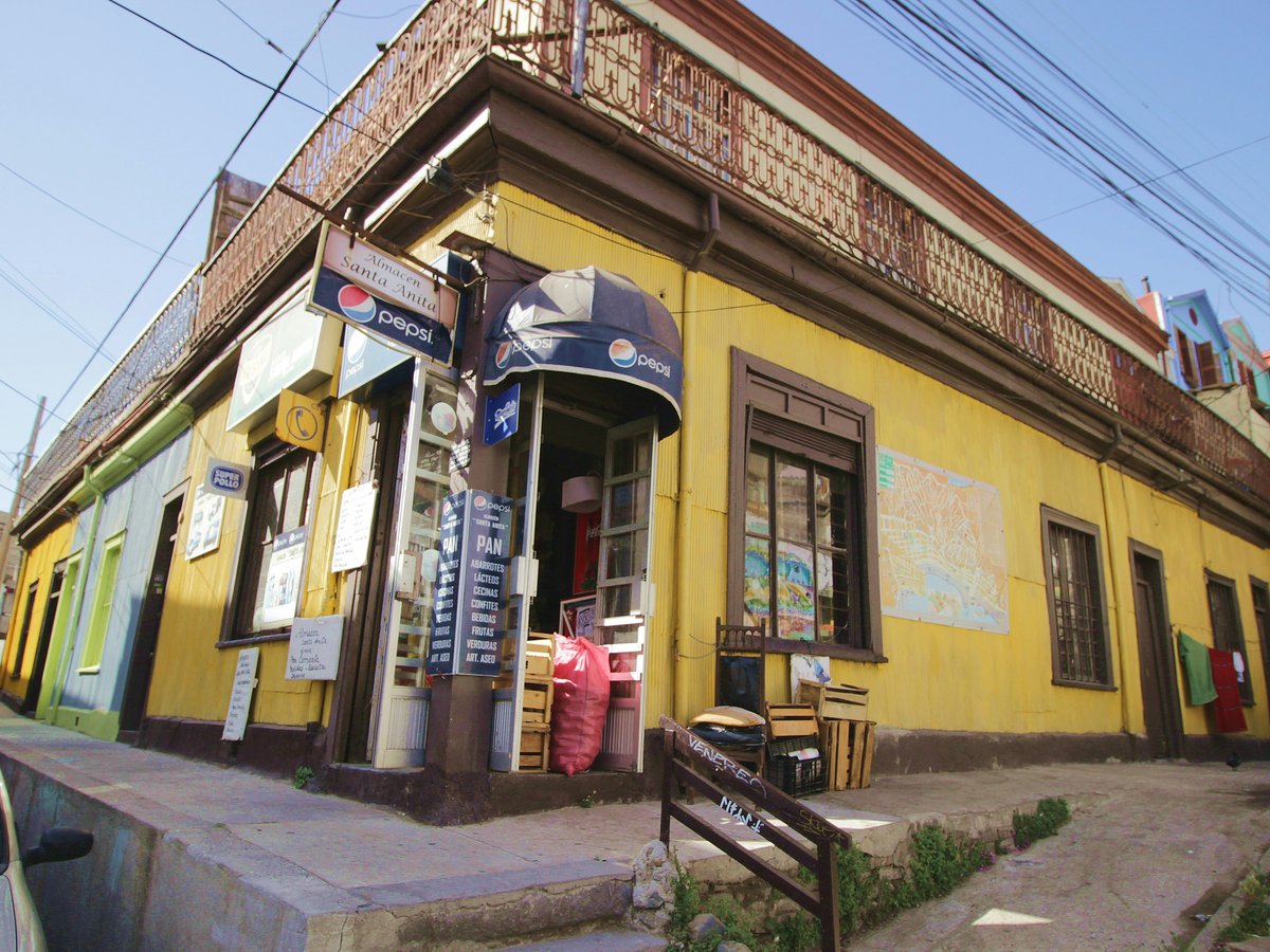 a yellow building with a bench