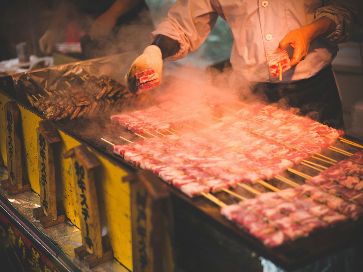 man grilling meat