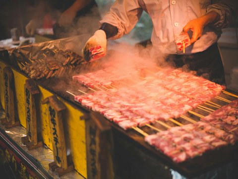 man grilling meat