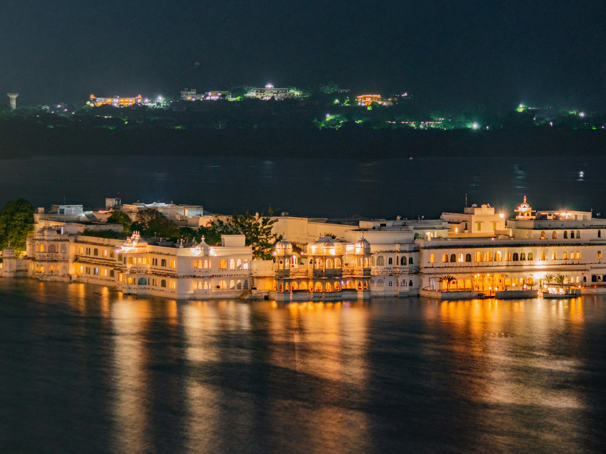 a large white building sitting on top of a body of water