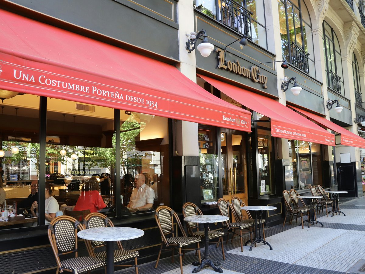 Outdoor cafe seating with red awnings