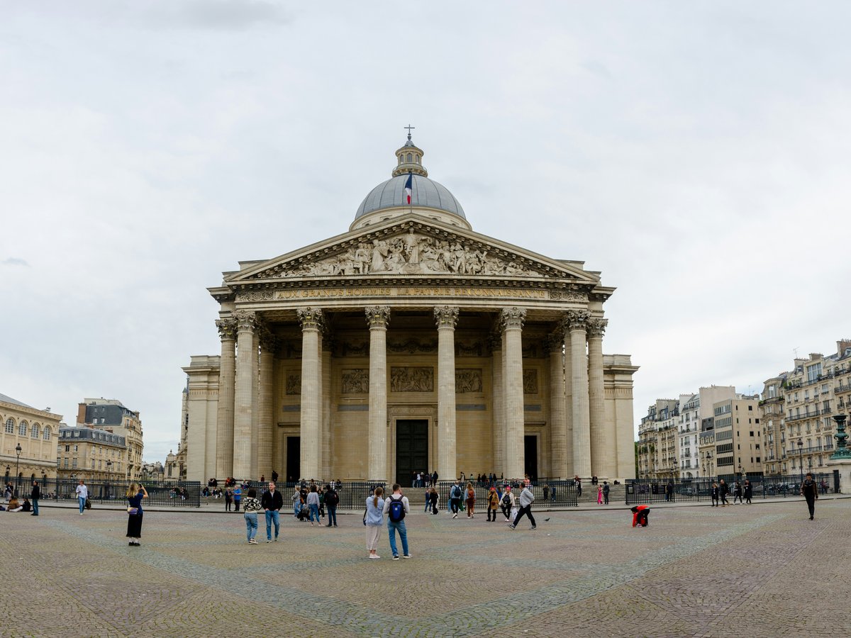 a group of people standing in front of a building