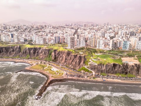 Coastal city with cliffs overlooking ocean waves