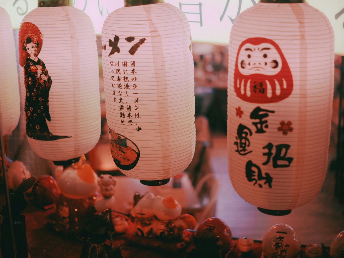 a group of paper lanterns hanging from a ceiling