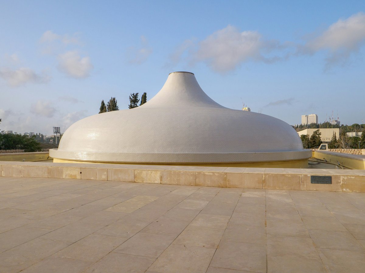 Distinctive white dome structure under a partly cloudy sky