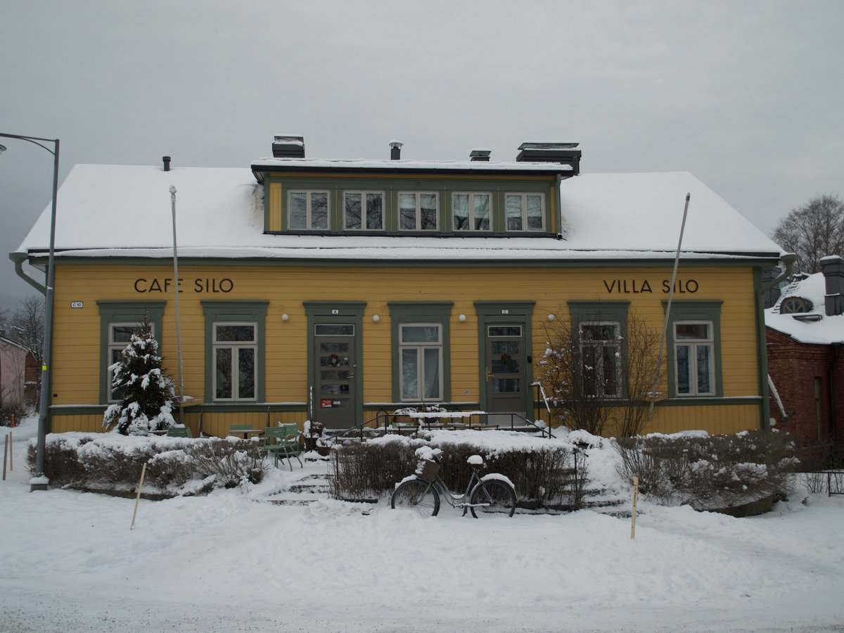 a yellow building with a bicycle parked in front of it