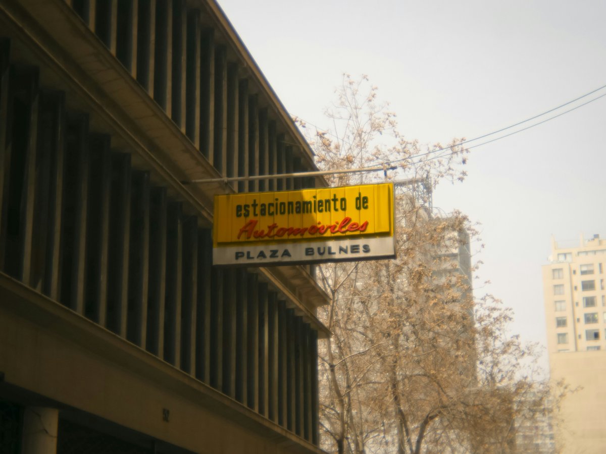 A street sign hanging from the side of a building