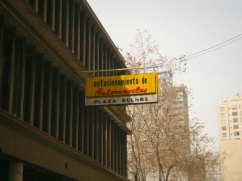 A street sign hanging from the side of a building