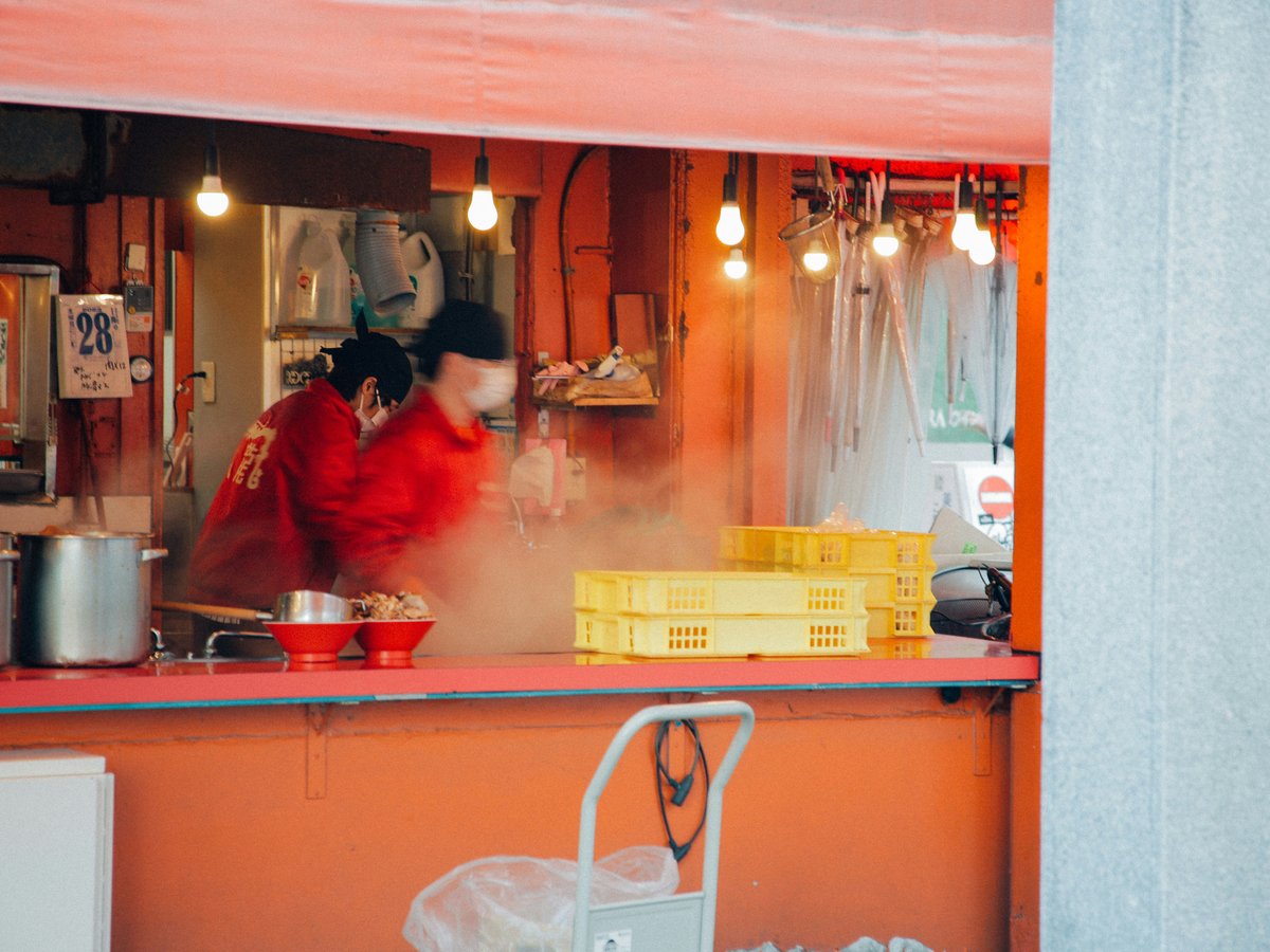 a couple of people that are cooking in a kitchen