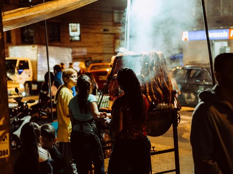 a group of people standing around a bbq