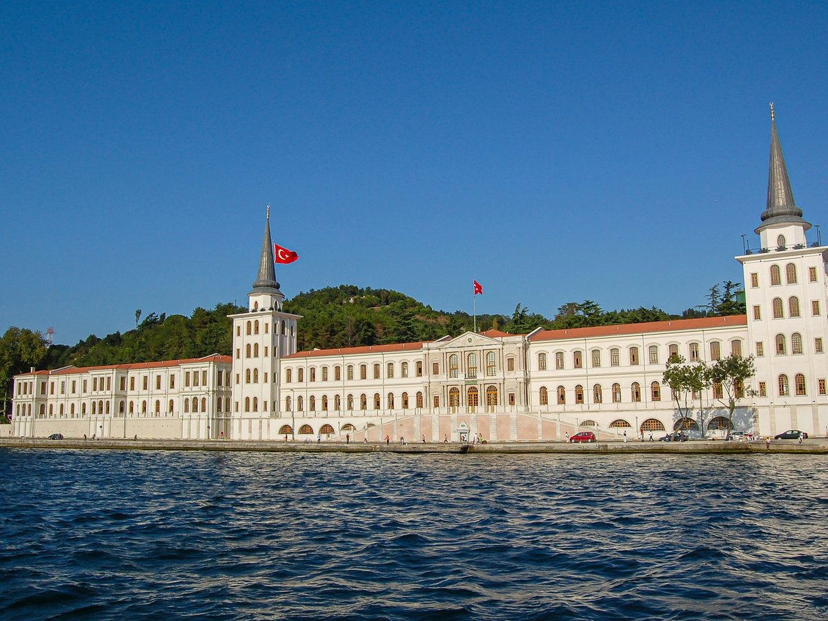 a large white building sitting on top of a body of water