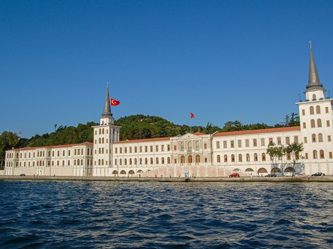 a large white building sitting on top of a body of water