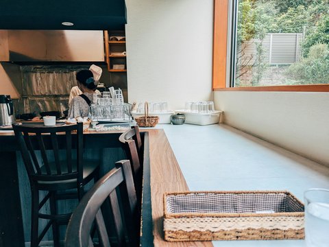 A woman standing at a counter in a restaurant